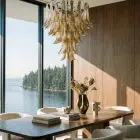 52 Murano glass amber lattimo chandelier haning in a diningroom with a seaview