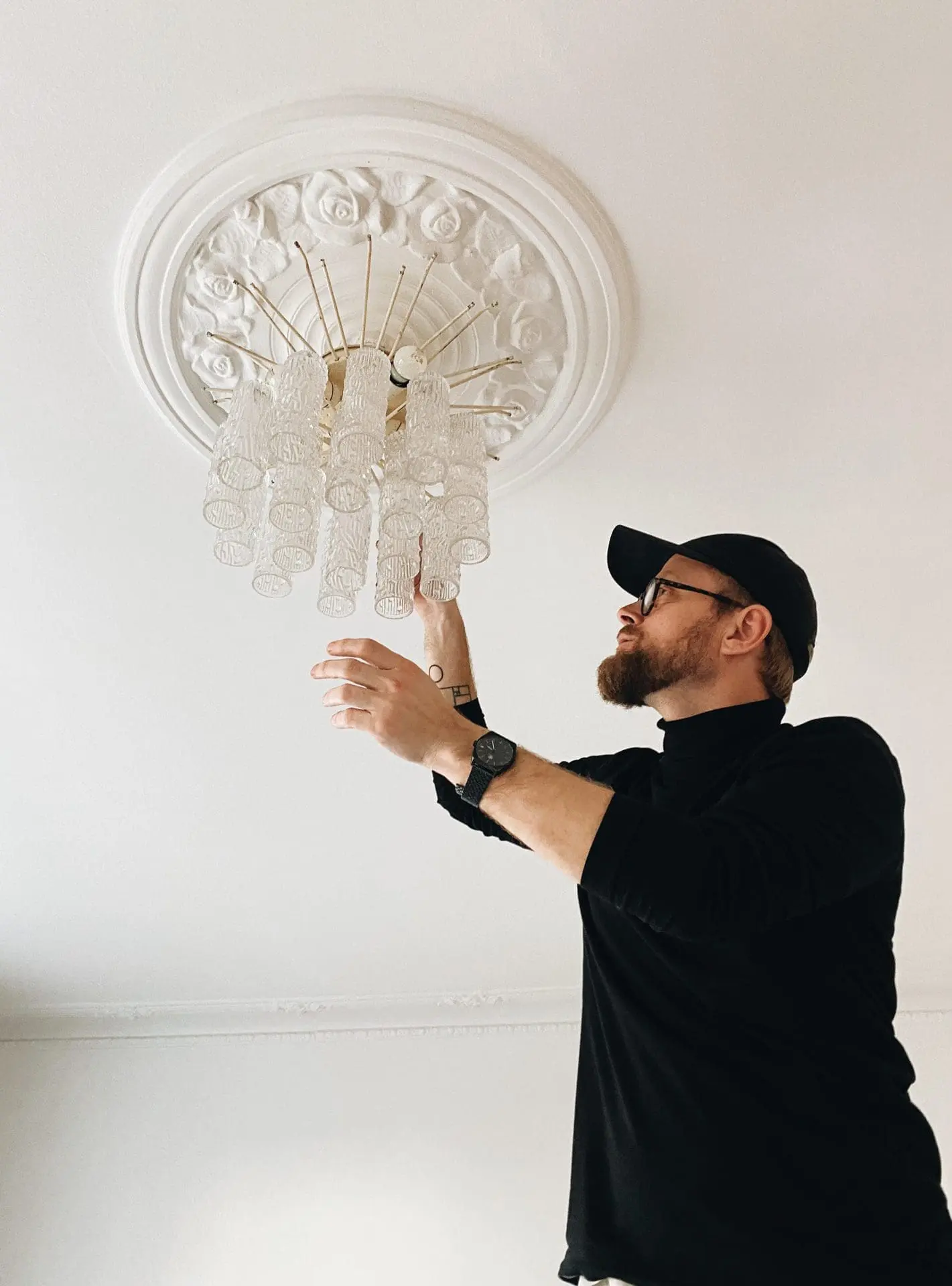 Jakob from cherry vintage hanging up a chandelier.