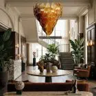52 amber felci Murano glass chandelier hanging in a hotel lobby