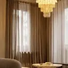 80 clear amber Murano tube chandelier hanging in livingroom
