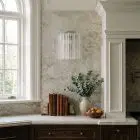 5 Murano transparent tube sconces hanging in kitchen