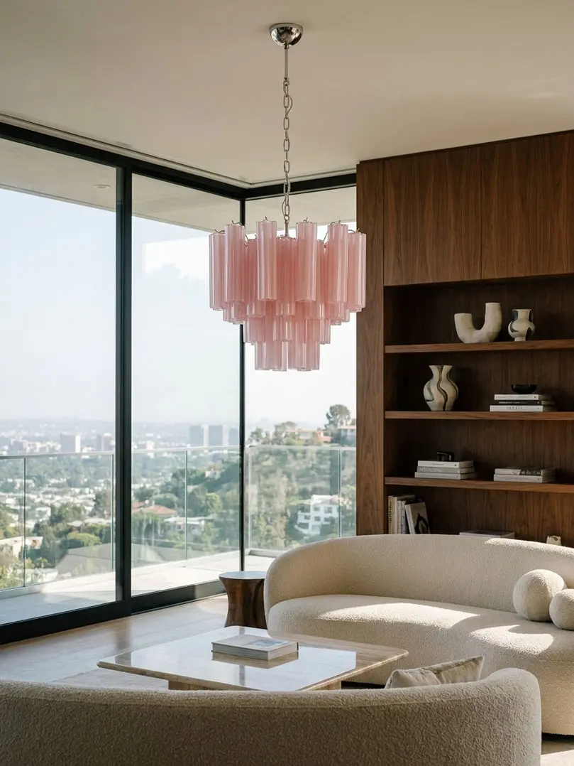 36 matte pink Murano glass tube chandelier hanging in a livingroom with a view.